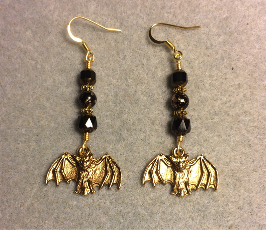 Gold bat charm earrings adorned with black Czech glass beads