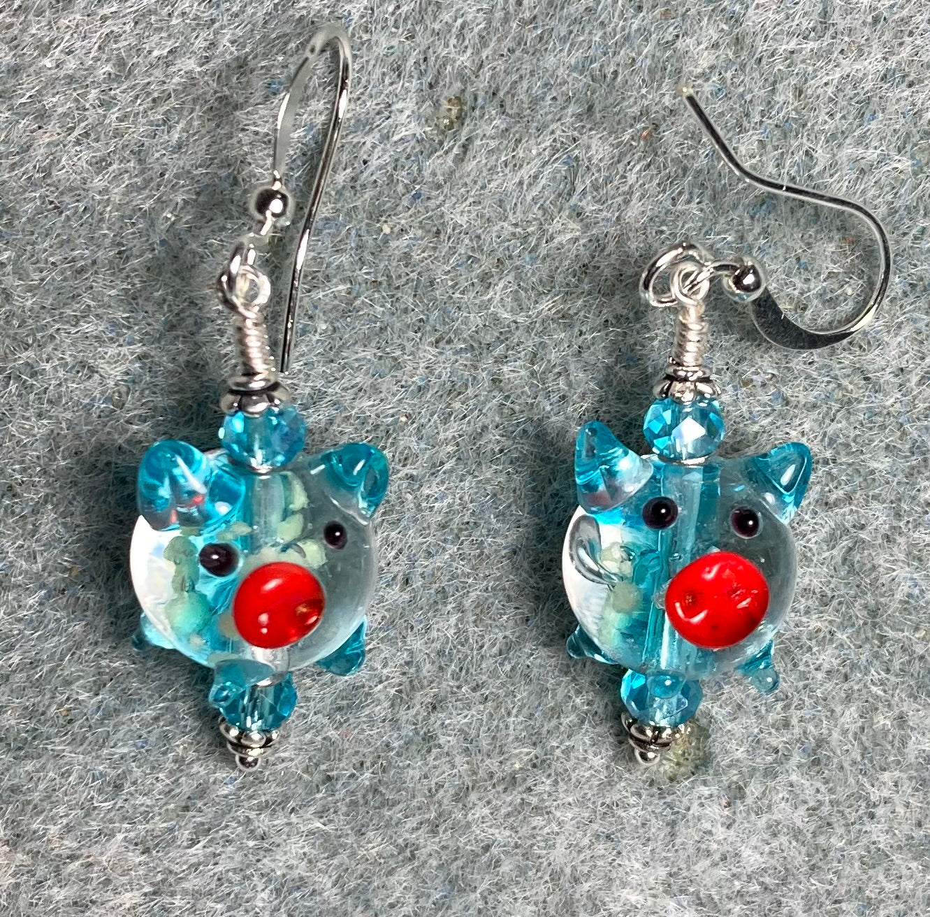 Turquoise, red, and clear glow in the dark lamp work pig bead earrings adorned with turquoise Chinese crystal beads.
