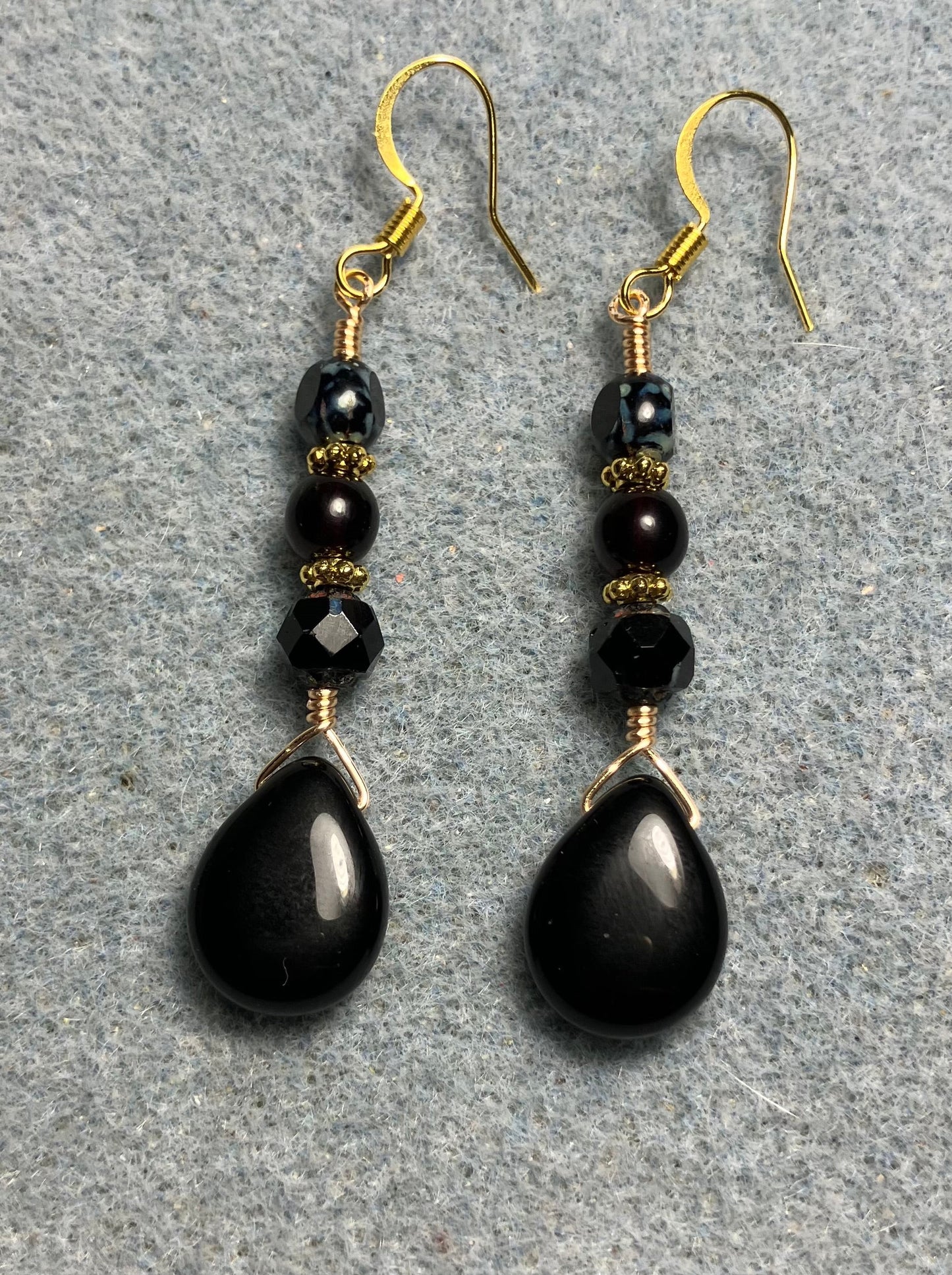 Black Czech glass pear drop bead earrings adorned with black Czech glass beads.