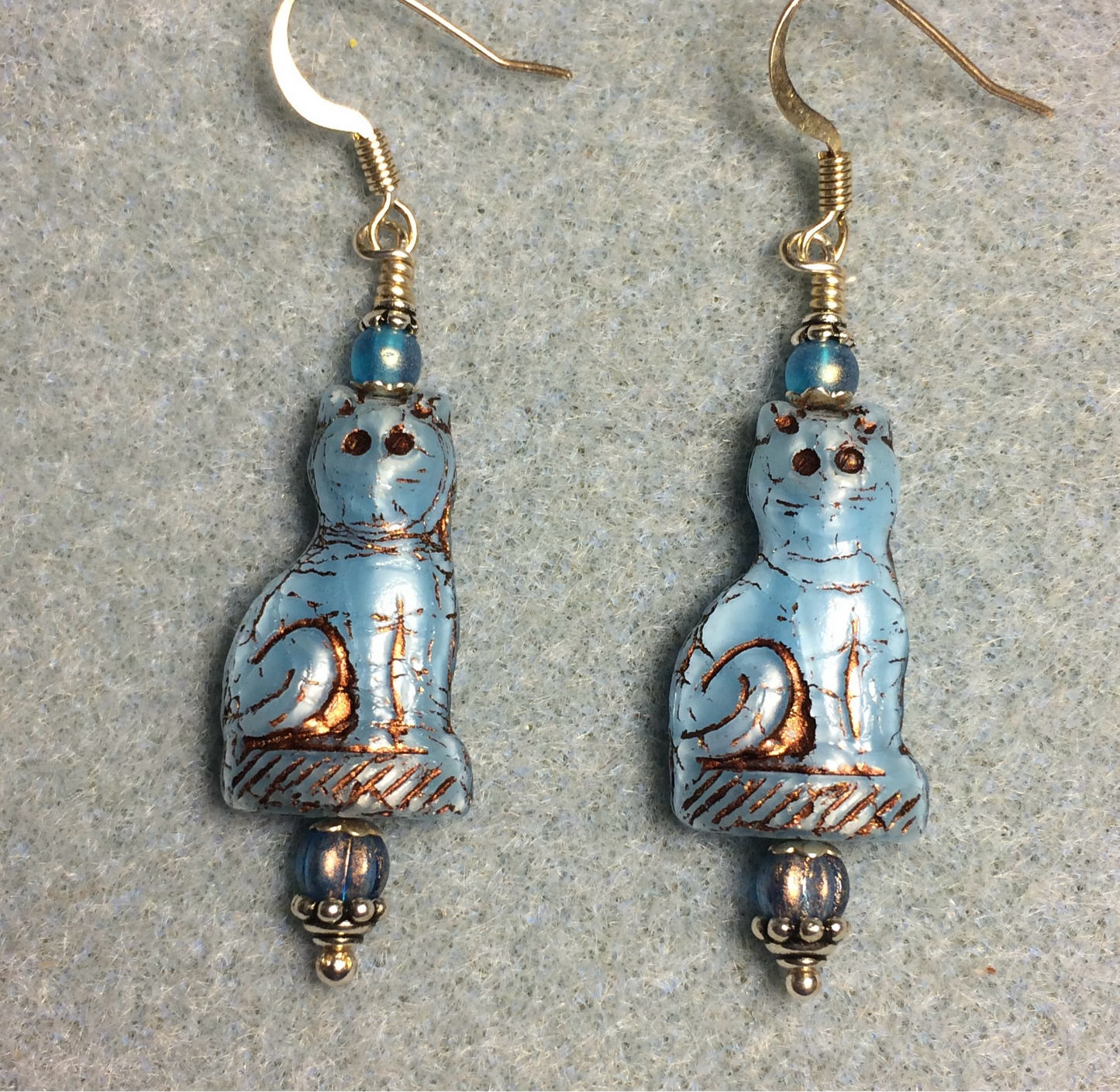 Opaque light blue (with copper inlay) fancy Czech glass cat bead earrings adorned with light blue Czech glass beads.