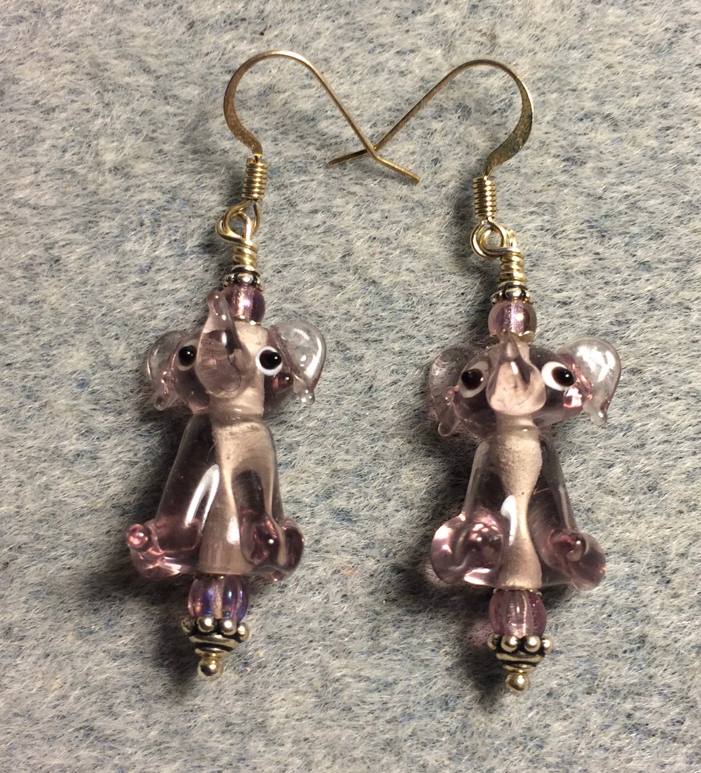 Translucent light violet lamp work sitting elephant bead earrings adorned with light violet Czech glass beads.