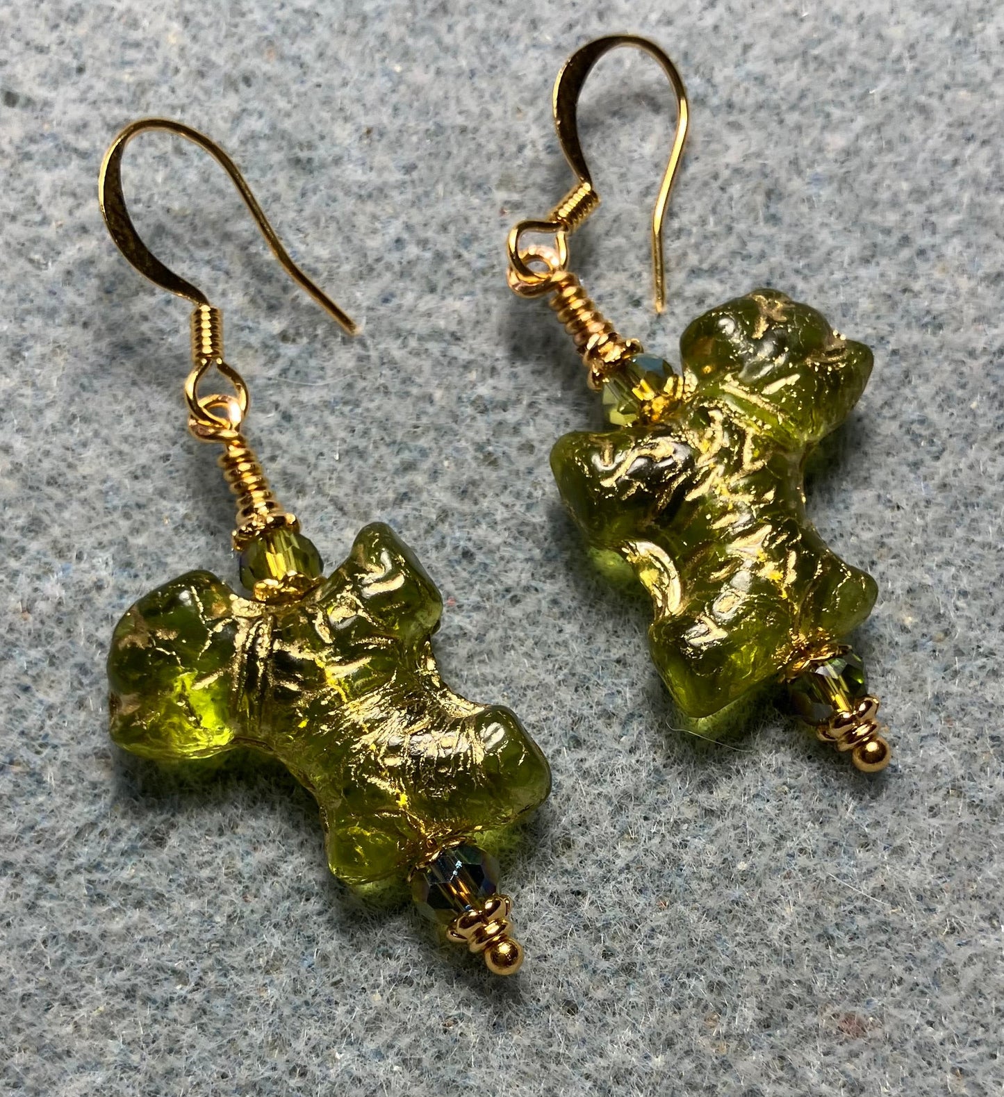 Olive green (with gold wash) Czech glass Schnauzer bead earrings adorned with sparkly olive green Chinese crystal beads.