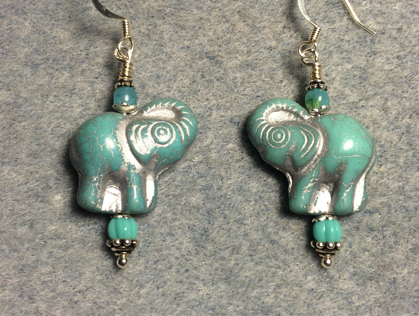 Opaque turquoise (with silver inlay) Czech glass elephant bead earrings adorned with turquoise Czech glass beads.