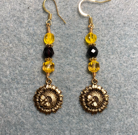 Gold sunflower and bee charm earrings adorned with yellow and black Czech glass beads