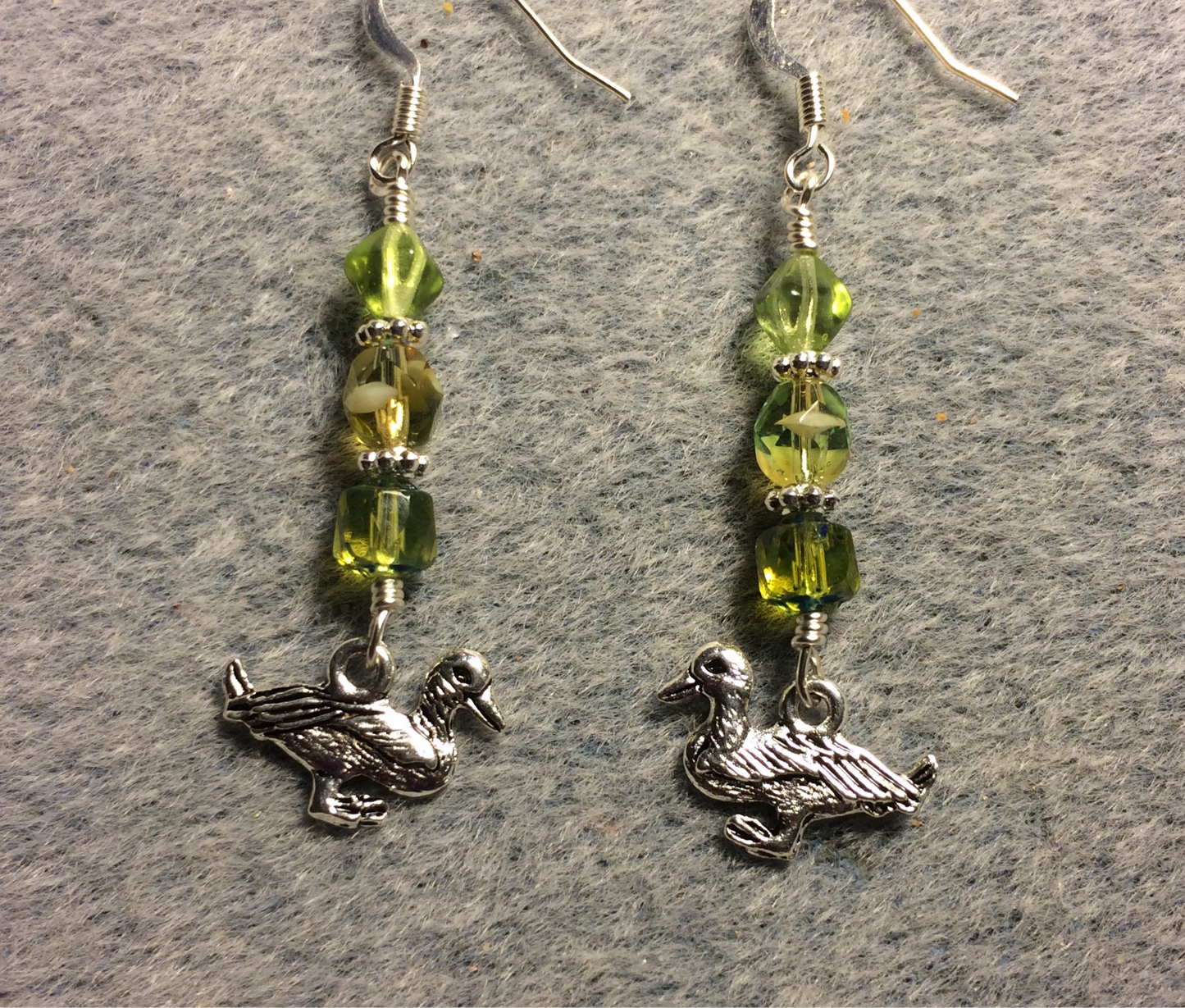 Silver mallard duck charm earrings adorned with olive green Czech glass beads