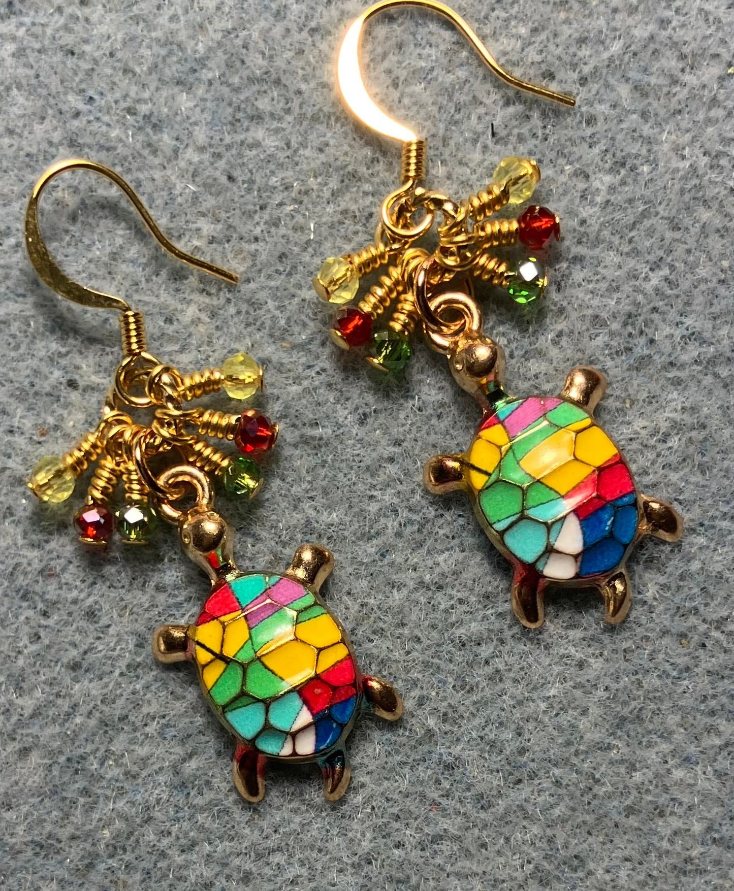 Green, red, yellow, blue, and pink enamel turtle charm earrings adorned with tiny dangling green, red, and yellow Chinese crystal beads.