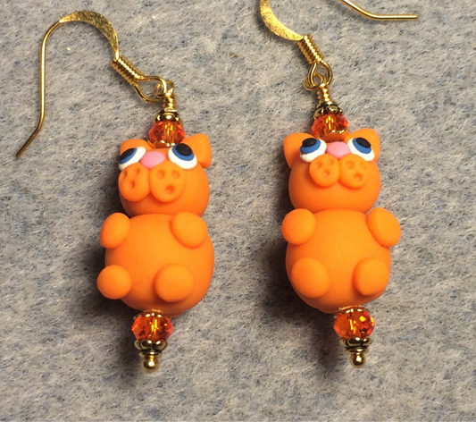 Orange polymer clay cat bead earrings adorned with orange Chinese crystal beads.