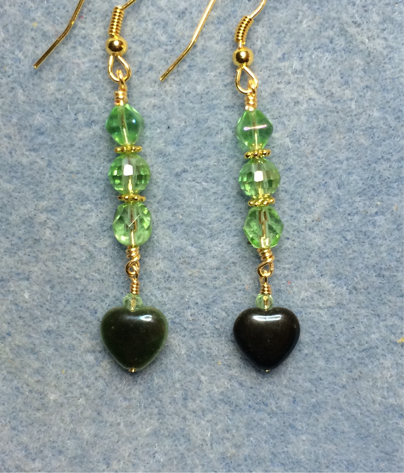 Small light green Czech glass heart bead earrings adorned with light green Czech glass beads.