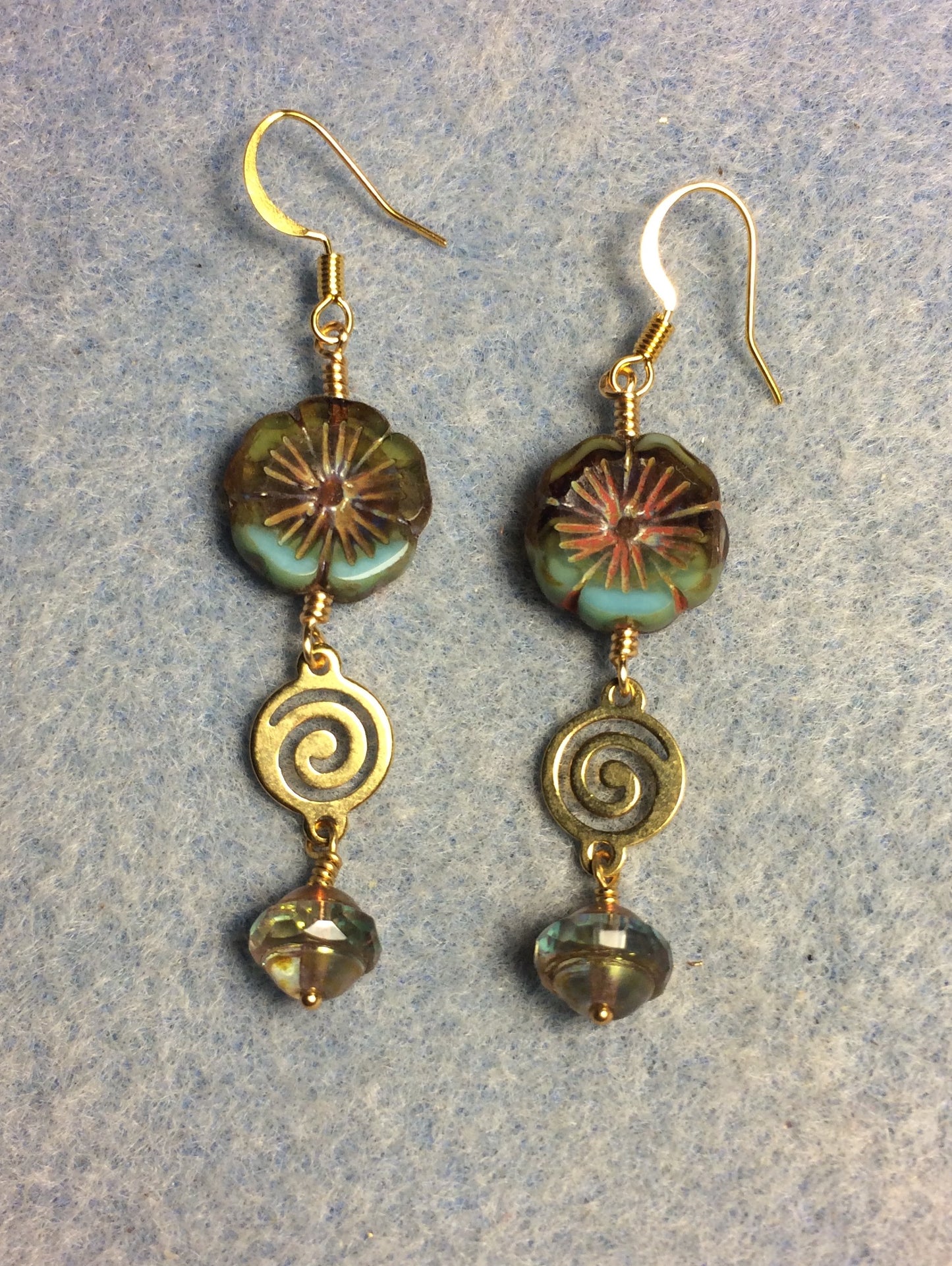 Olive green and blue Czech glass pansy bead earrings adorned with gold swirly connectors and blue green Czech glass Saturn beads.