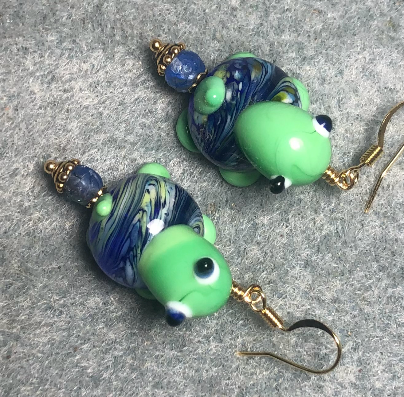 Bright blue and green lamp work turtle bead earrings adorned with blue Czech glass beads.