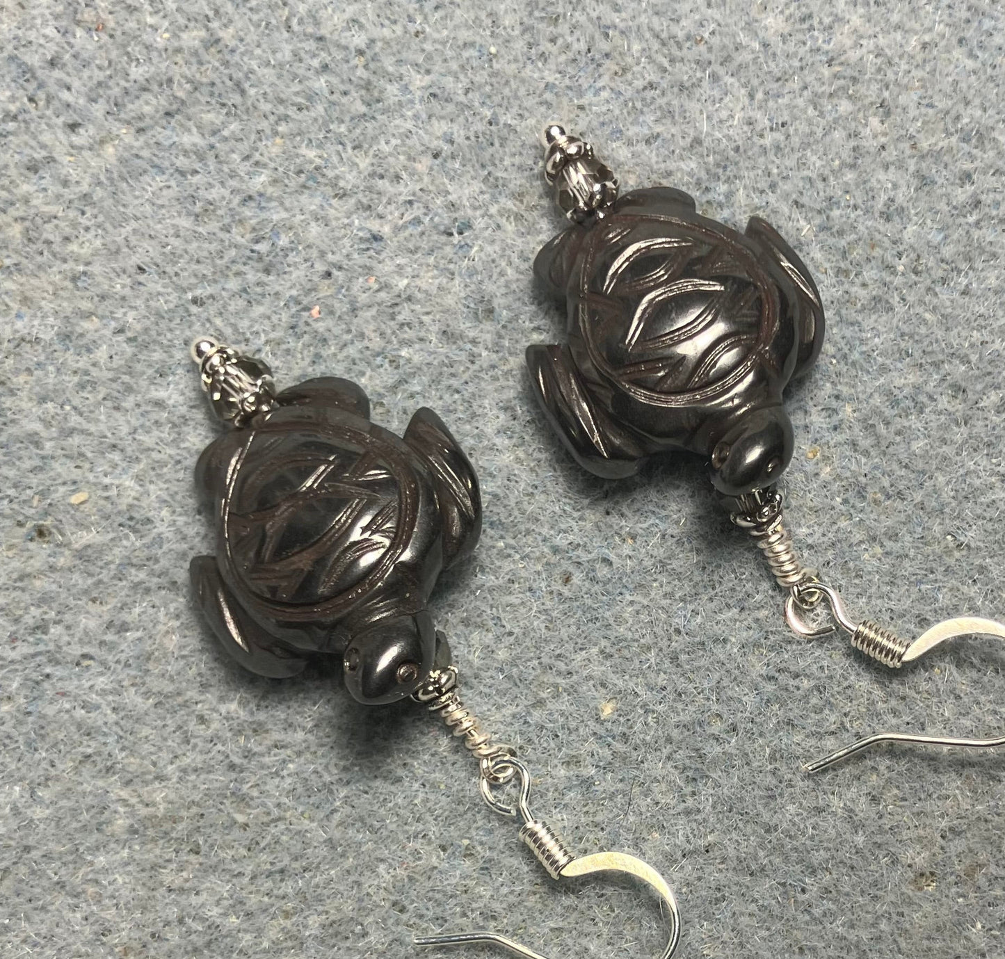 Hematite gemstone sea turtle bead earrings adorned with gray Chinese crystal beads.