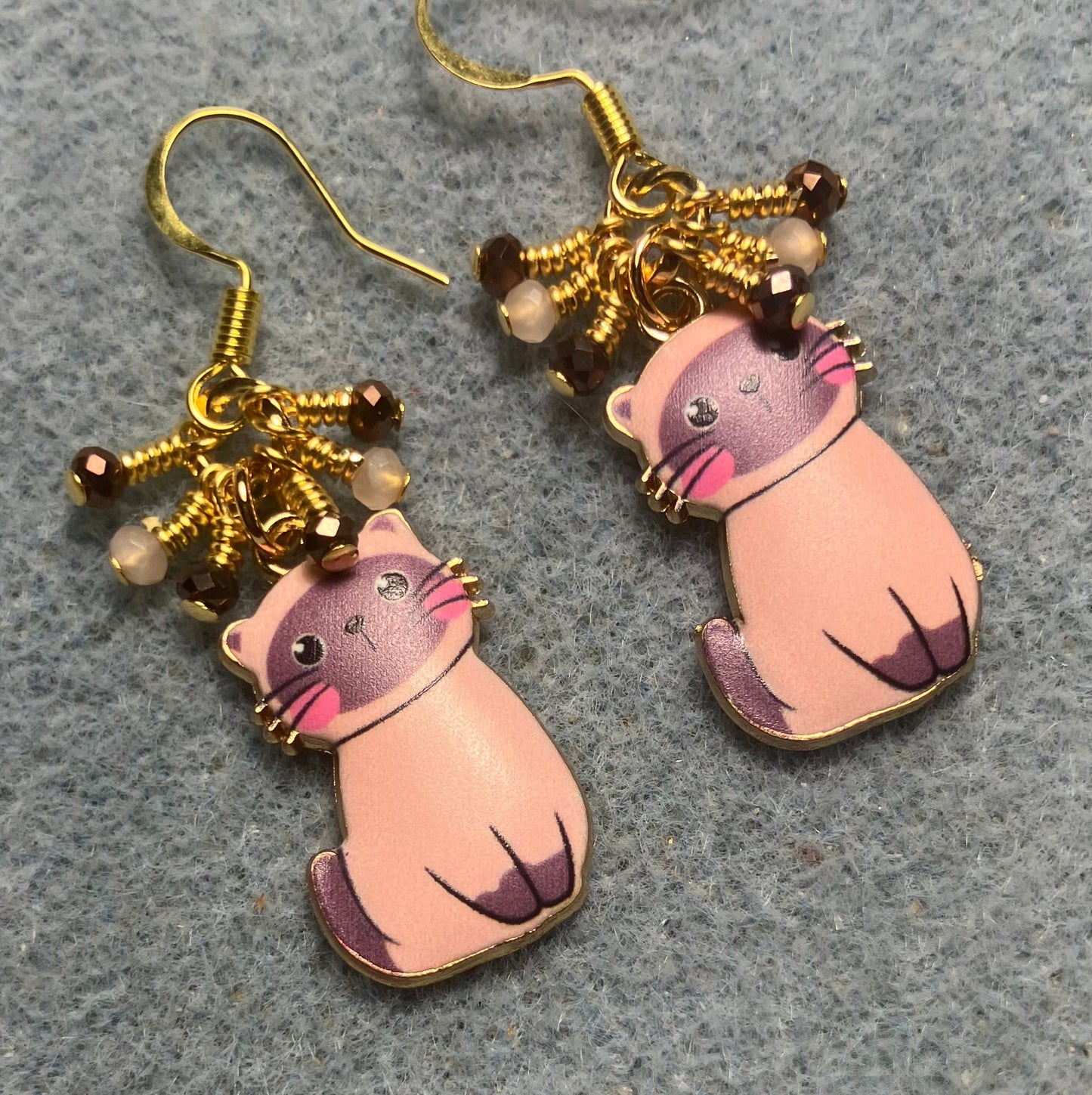 Brown and peach enamel cat charm earrings adorned with tiny dangling brown and peach Chinese crystal beads.