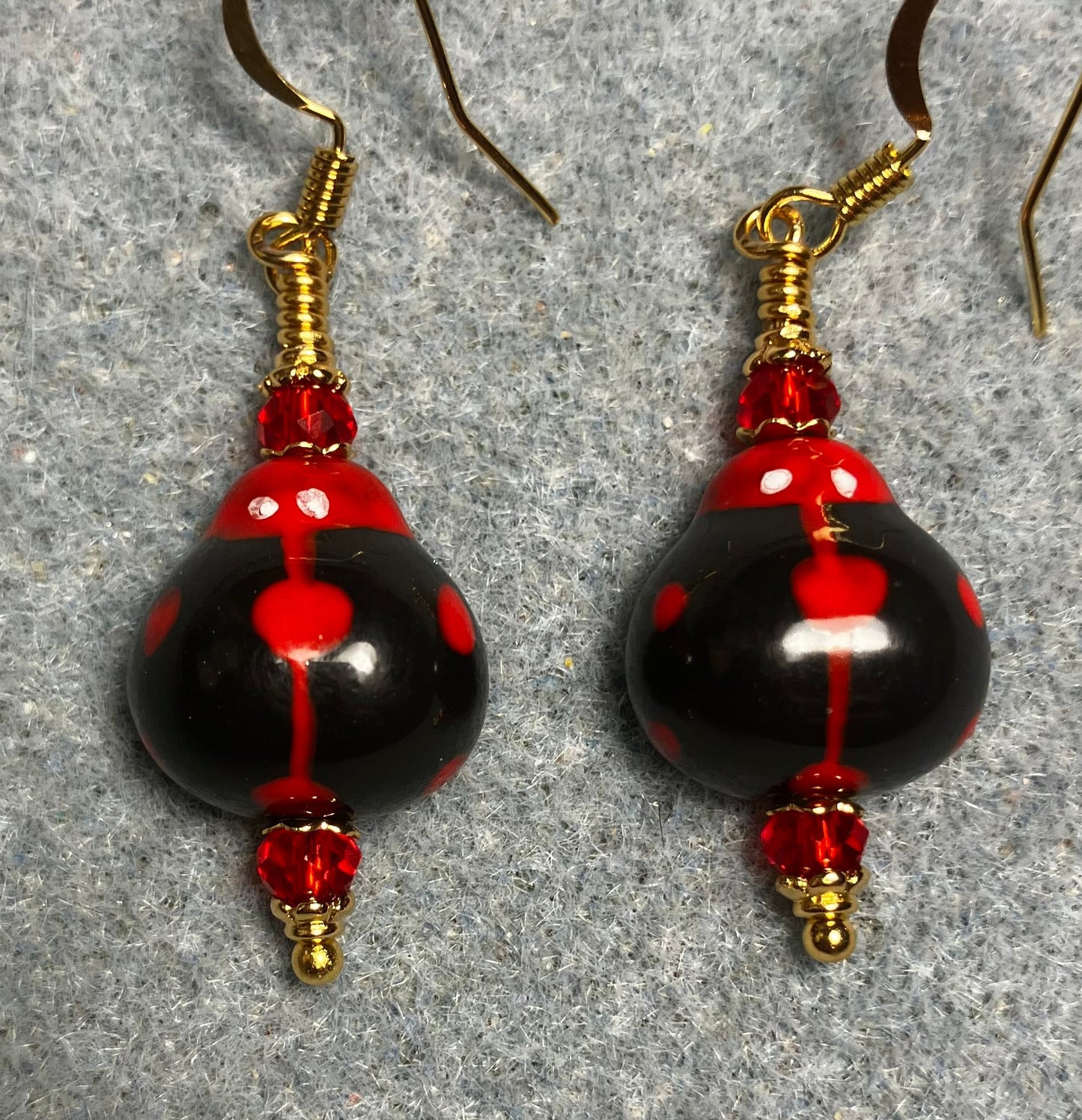 Black and red ceramic ladybug bead earrings adorned with red Chinese crystal beads.