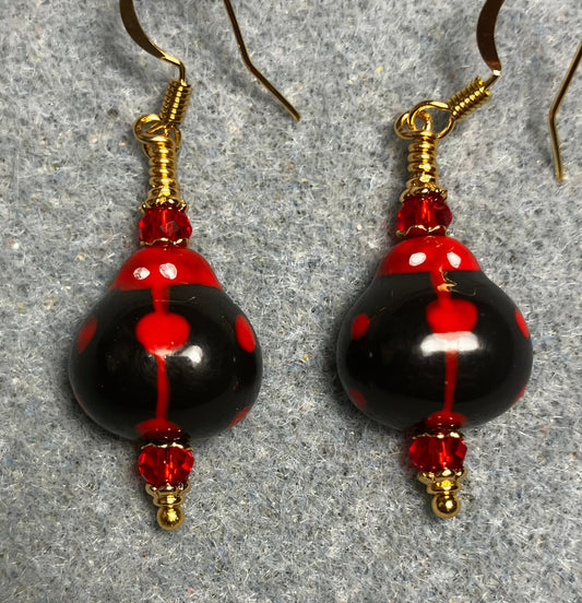 Black and red ceramic ladybug bead earrings adorned with red Chinese crystal beads.
