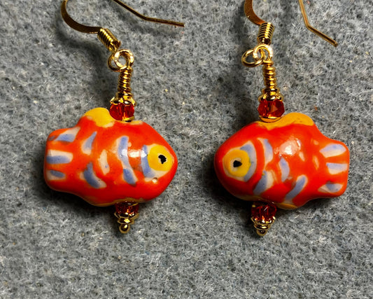 Orange, blue, and yellow ceramic spotted fish bead earrings adorned with orange Chinese crystal beads.