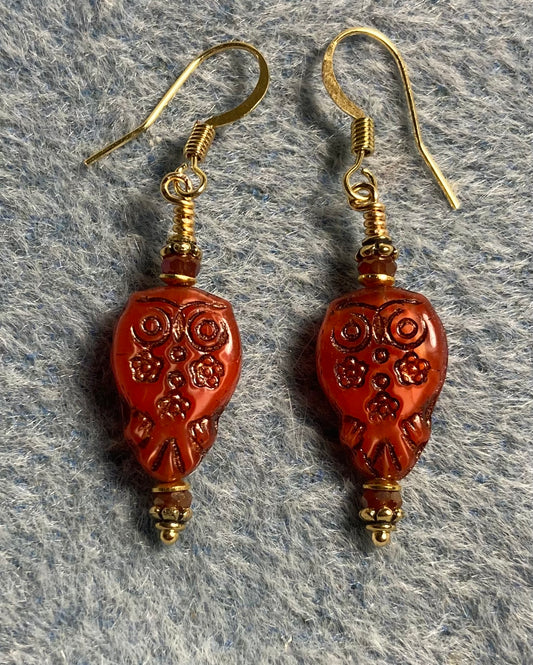 Small orange red Czech glass owl bead earrings adorned with small orange red Chinese crystal beads.