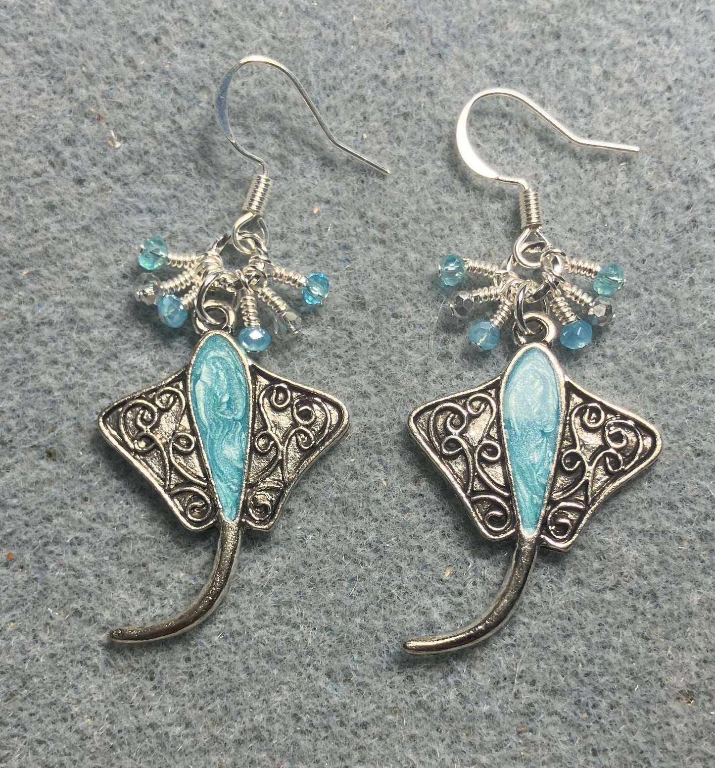 Silver and turquoise enamel stingray charm earrings adorned with tiny dangling turquoise and silver Chinese crystal beads.