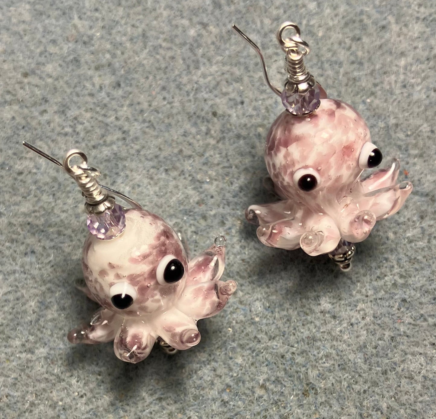 Light violet and white mottled lamp work octopus bead earrings adorned with light violet Chinese crystal beads.