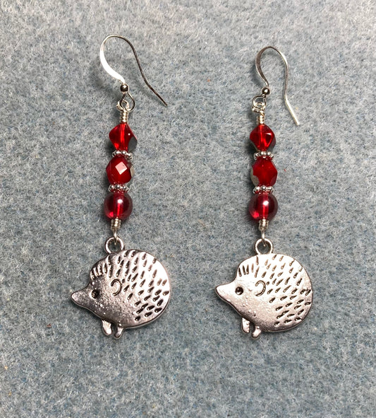 Silver porcupine (or hedgehog) charm earrings adorned with red Czech glass beads