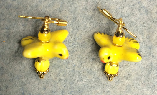 Yellow ceramic flying bird bead earrings adorned with yellow Czech glass beads.