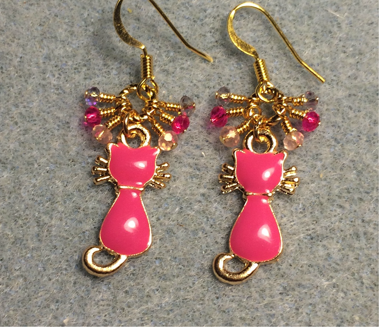 Small hot pink and gold enamel cat charm earrings adorned with tiny dangling hot pink and light pink Chinese crystal beads.