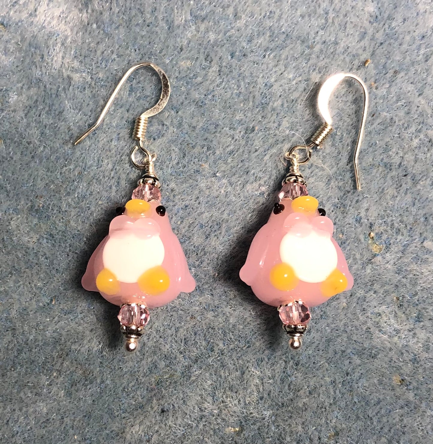 Pink and white lamp work penguin bead earrings adorned with pink Chinese crystal beads.