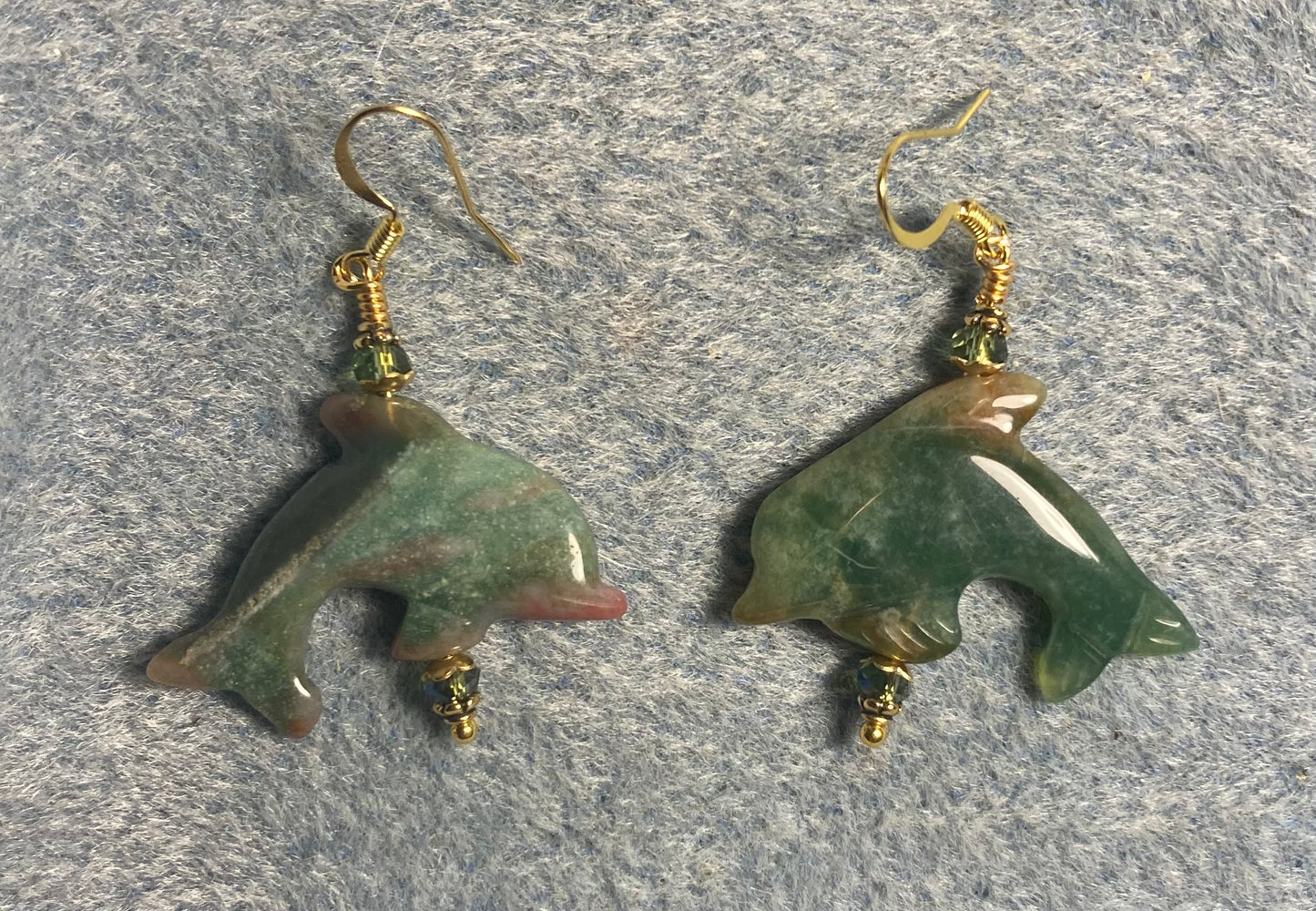 Green Indian agate gemstone dolphin bead earrings adorned with sparkly green Chinese crystal beads.