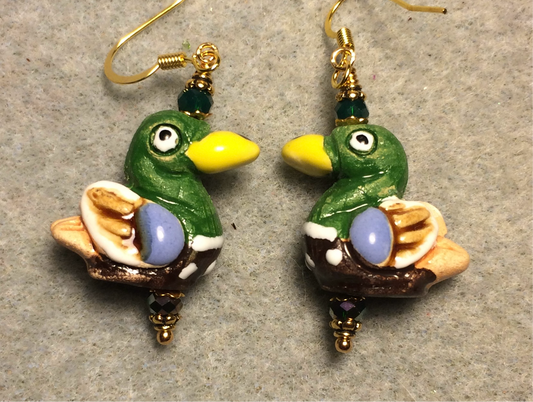 Dark green, yellow, and blue ceramic duck bead earrings adorned with dark green Czech glass beads.