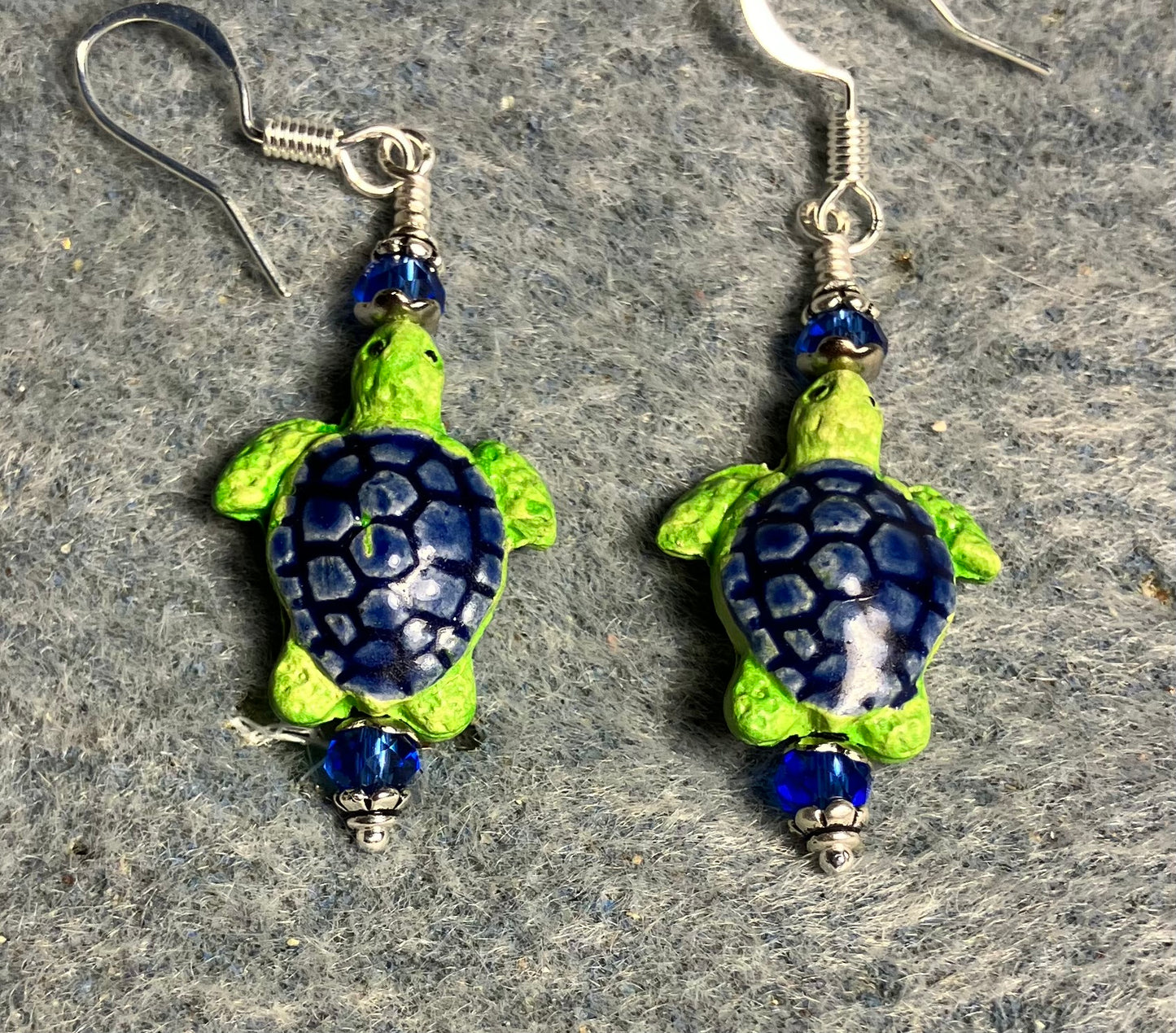 Small dark blue and green ceramic sea turtle bead earrings adorned with dark blue Chinese crystal beads.