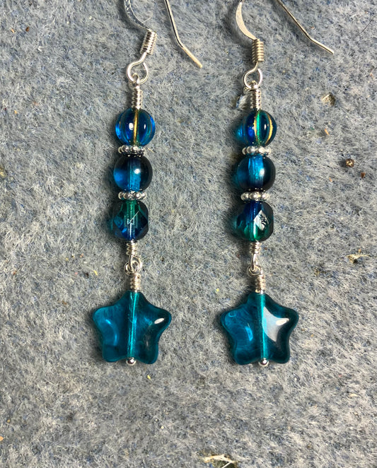 Small translucent dark turquoise Czech glass star bead earrings adorned with dark turquoise Czech glass beads.