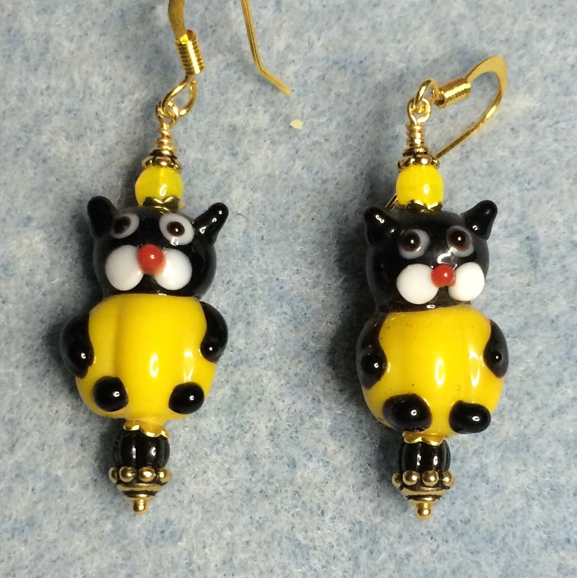 Yellow and black lamp cat bead earrings adorned with yellow and black Czech glass beads.