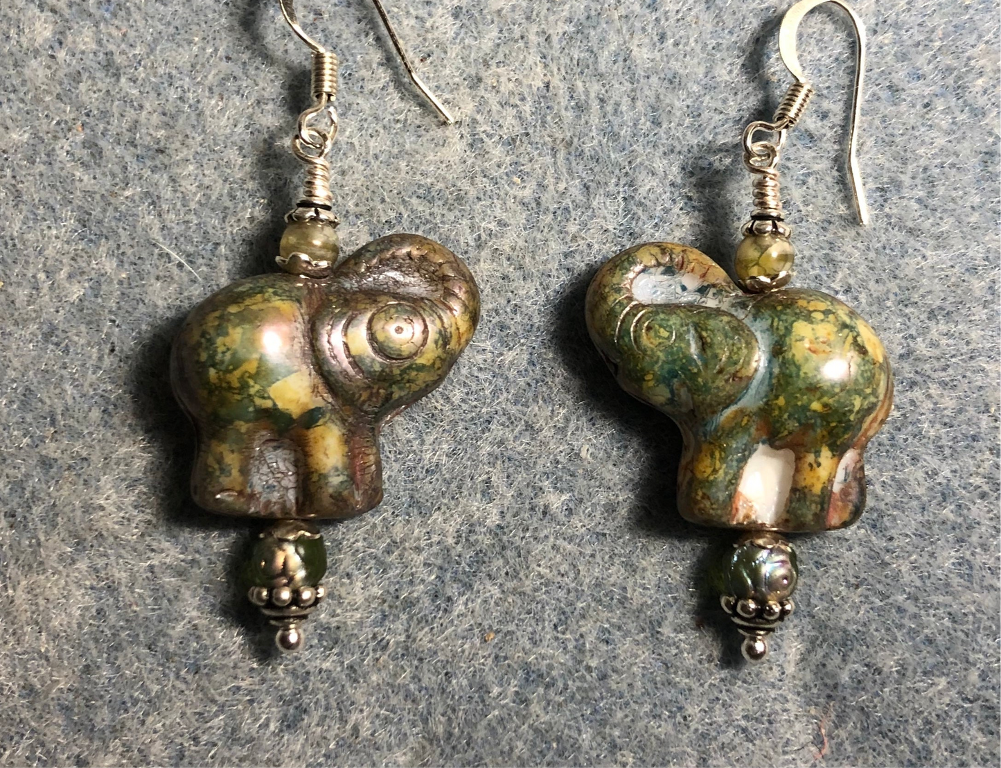 Olive green Czech glass elephant bead earrings adorned with olive green Czech glass beads.