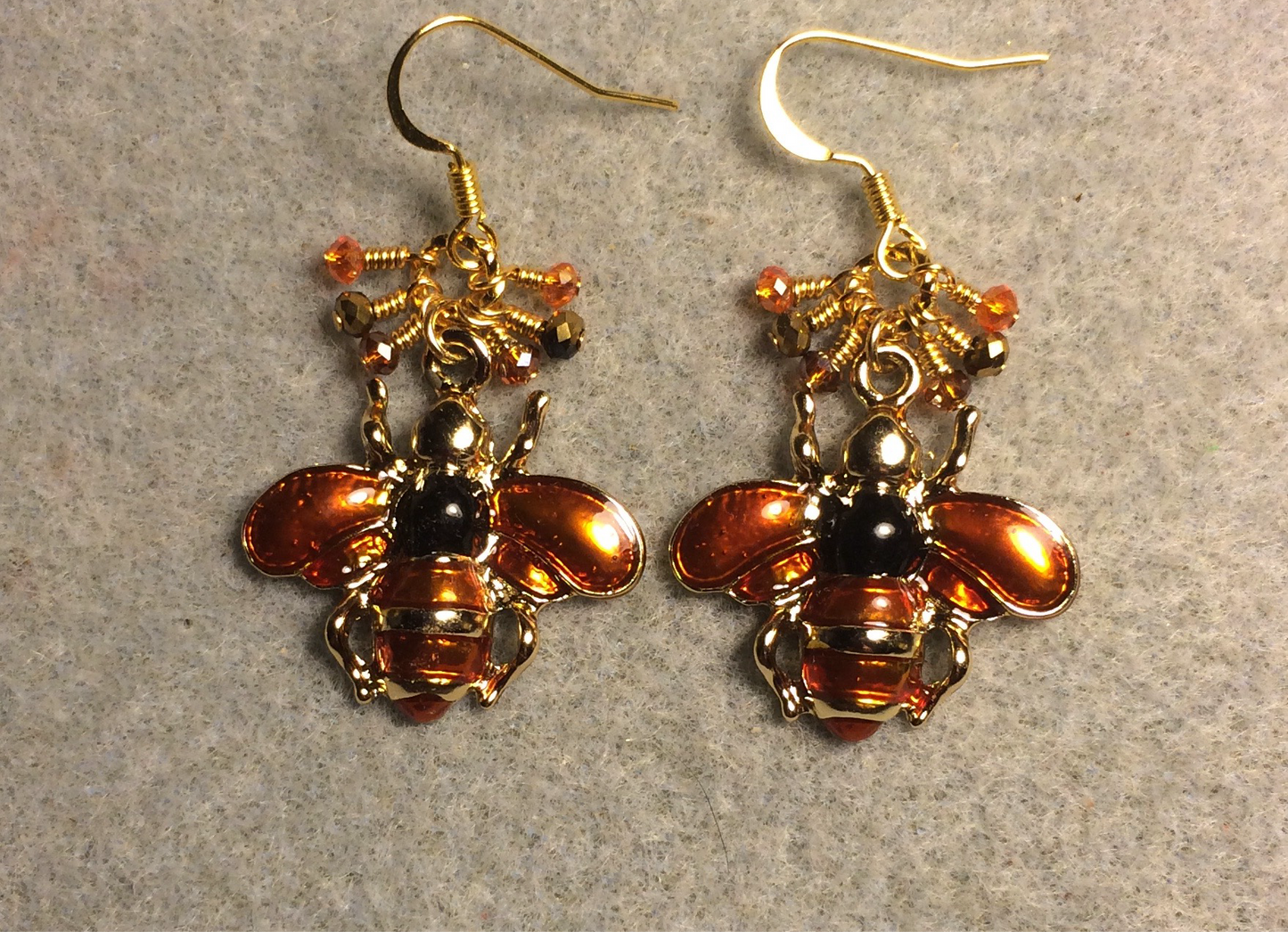 Orange and black enamel honeybee charm earrings adorned with tiny dangling orange and black Chinese crystal beads.