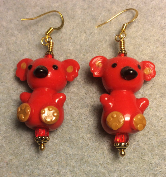 Large red lamp work koala bear bead earrings adorned with red Czech glass beads.