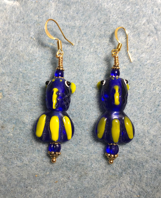 Blue and yellow lamp work striped fish bead earrings adorned with blue Czech glass beads.