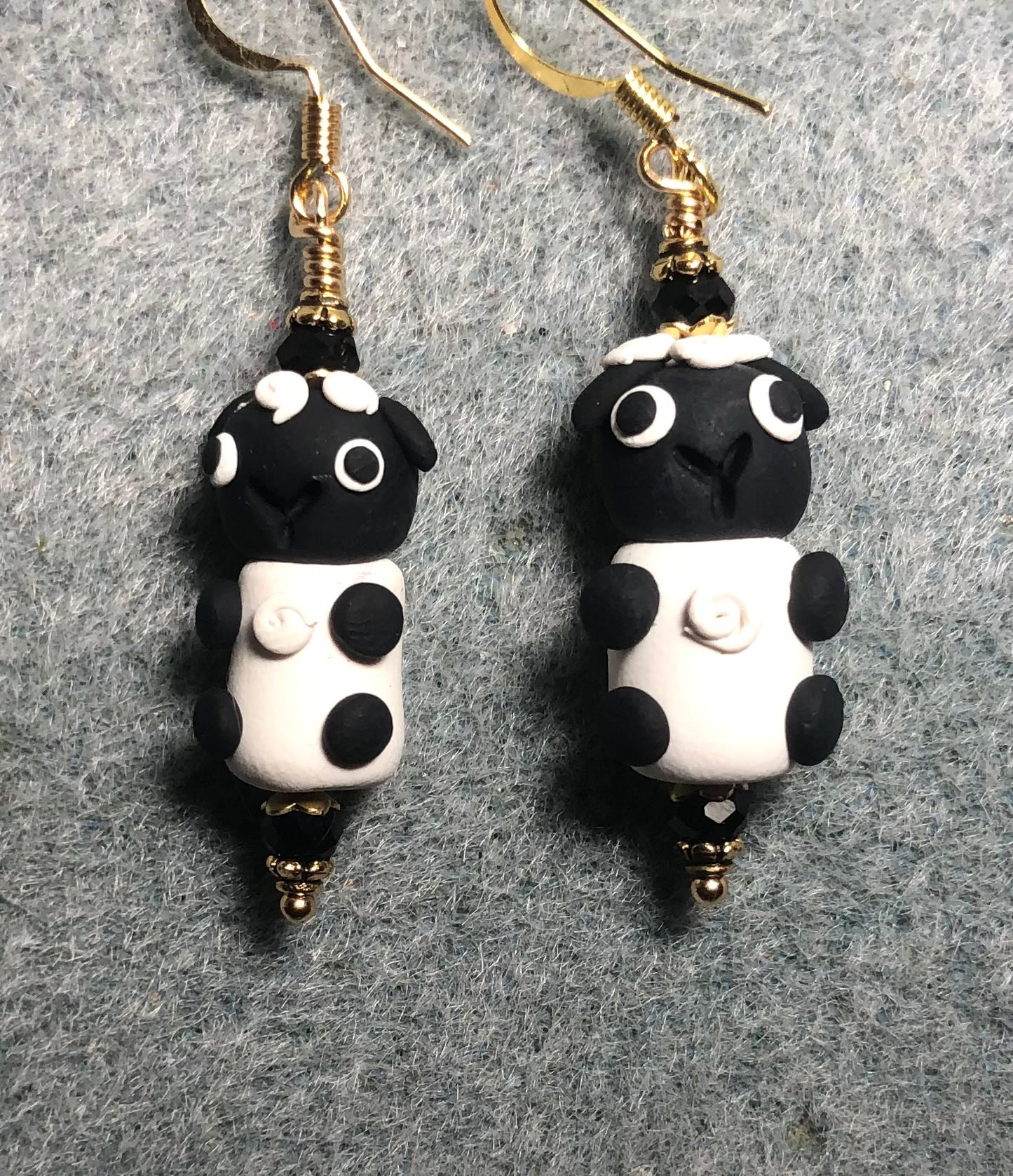 Black and white polymer clay sheep bead earrings adorned with black Chinese crystal beads.