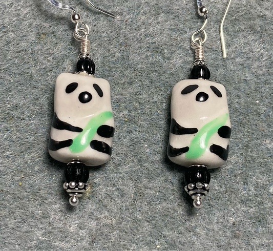 Black, white, and green ceramic panda bear bead earrings adorned with black Czech glass beads.