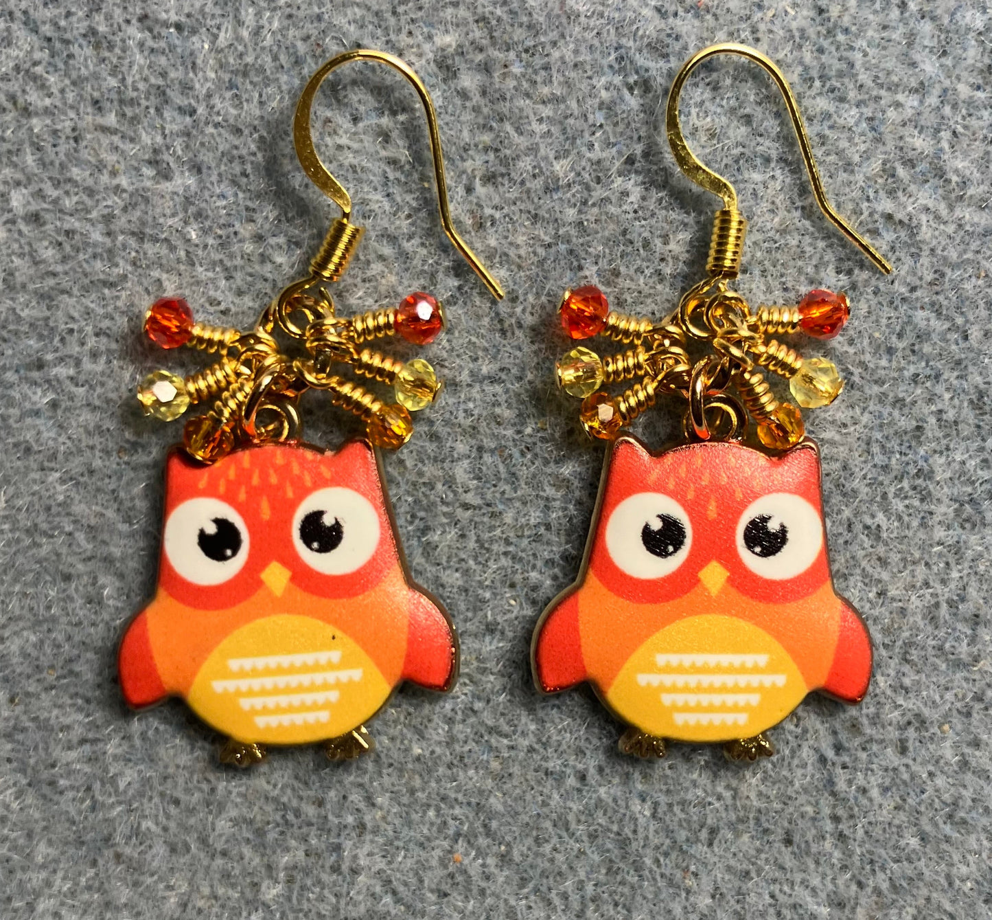 Orange and yellow enamel owl charm earrings adorned with tiny dangling orange and yellow Chinese crystal beads.
