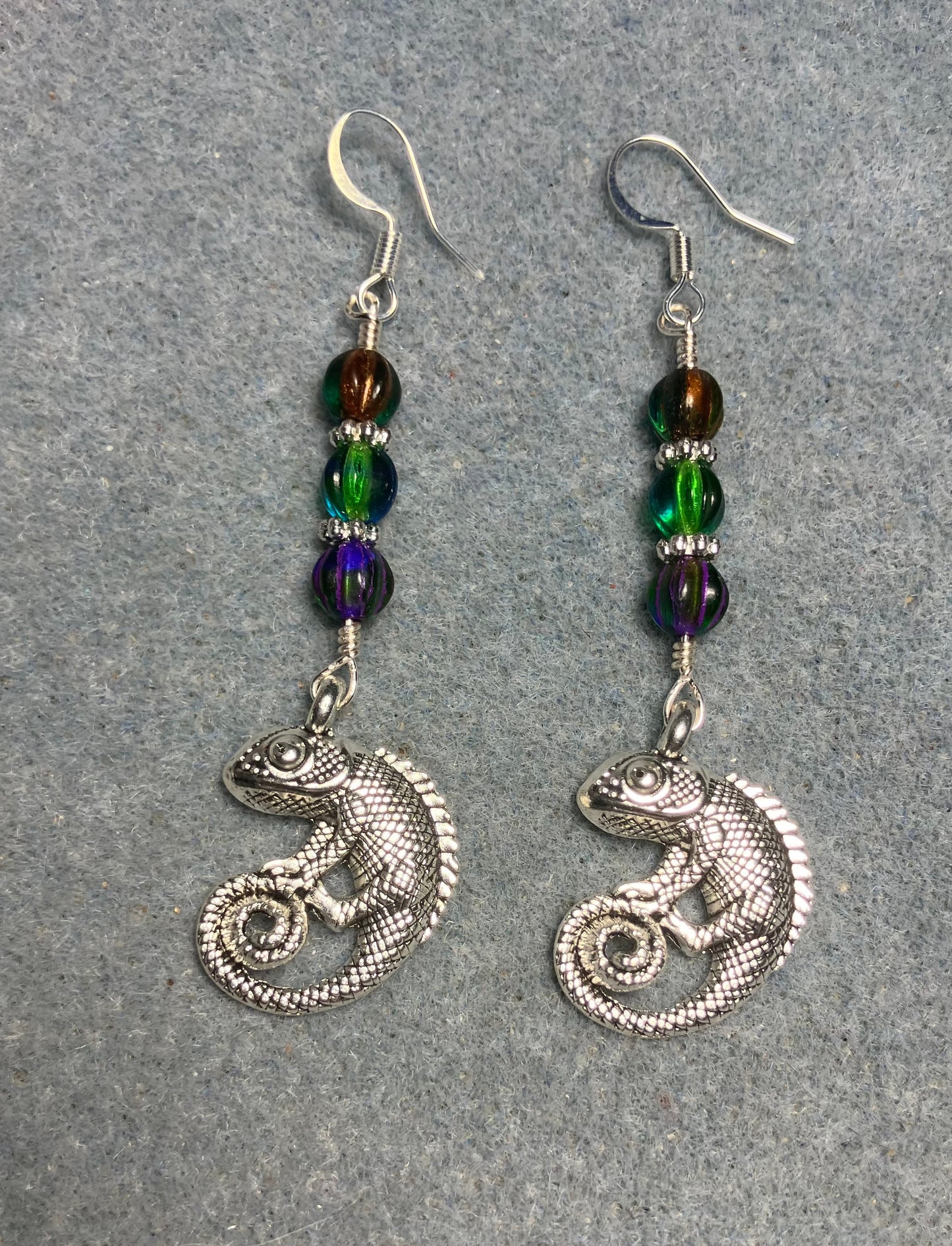 Large silver chameleon charm earrings adorned with green, purple green, and orange green Czech glass melon beads.
