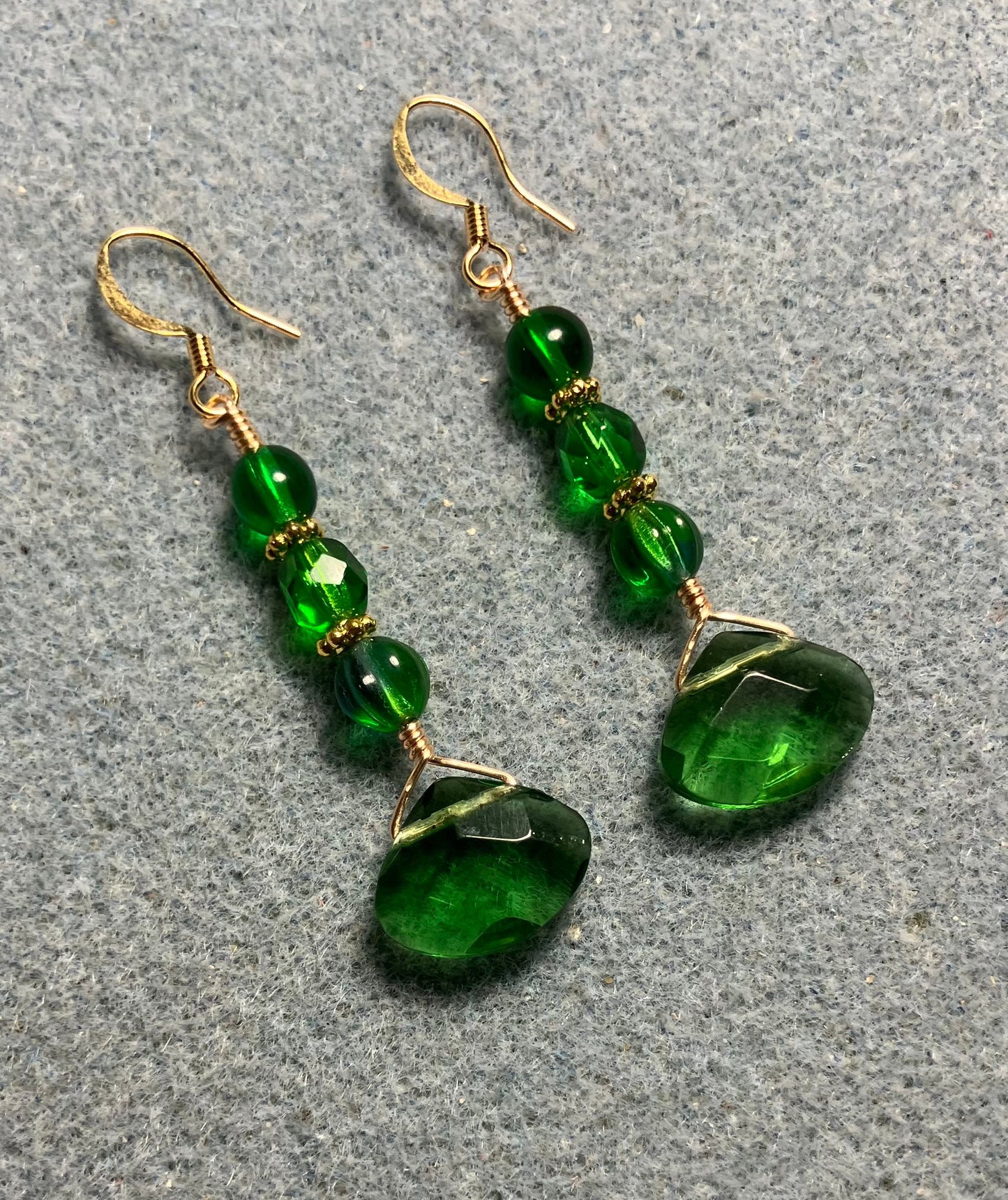 Emerald green Czech glass briolette bead earrings adorned with emerald green Czech glass beads.