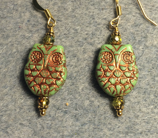 Green (with copper wash) Czech glass owl bead earrings adorned with sparkly green Chinese crystal beads.