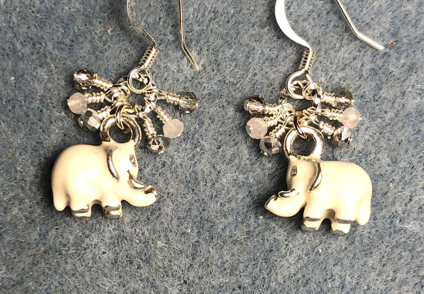 Small silver and white enamel elephant charm earrings adorned with tiny dangling silver and white Chinese crystal beads.