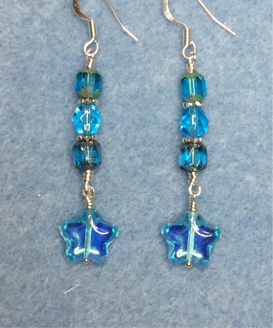 Small light sparkly turquoise Czech glass star bead earrings adorned with light turquoise Czech glass beads.