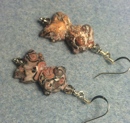 Carved pink leopard skin jasper gemstone goldfish bead earrings adorned with pink Chinese crystal beads.