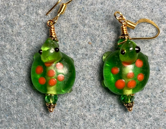 Olive green with orange spots lamp work turtle bead earrings adorned with olive green Chinese crystal beads.