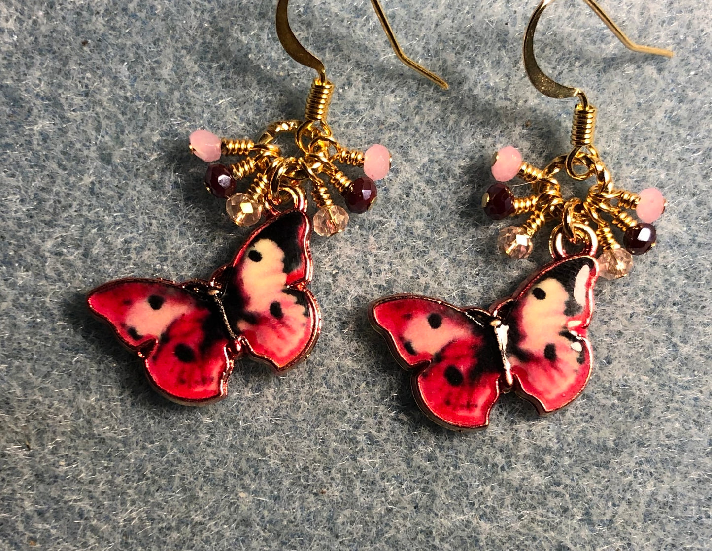 Pink, red, and black enamel butterfly charm earrings adorned with tiny dangling pink and red Chinese crystal beads.