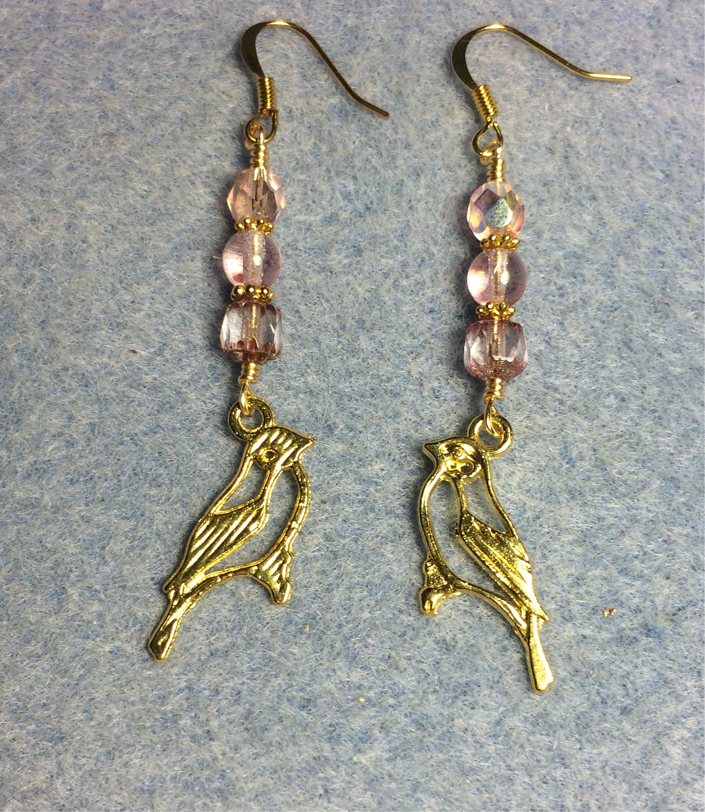 Gold songbird charm earrings adorned with light pink Czech glass beads
