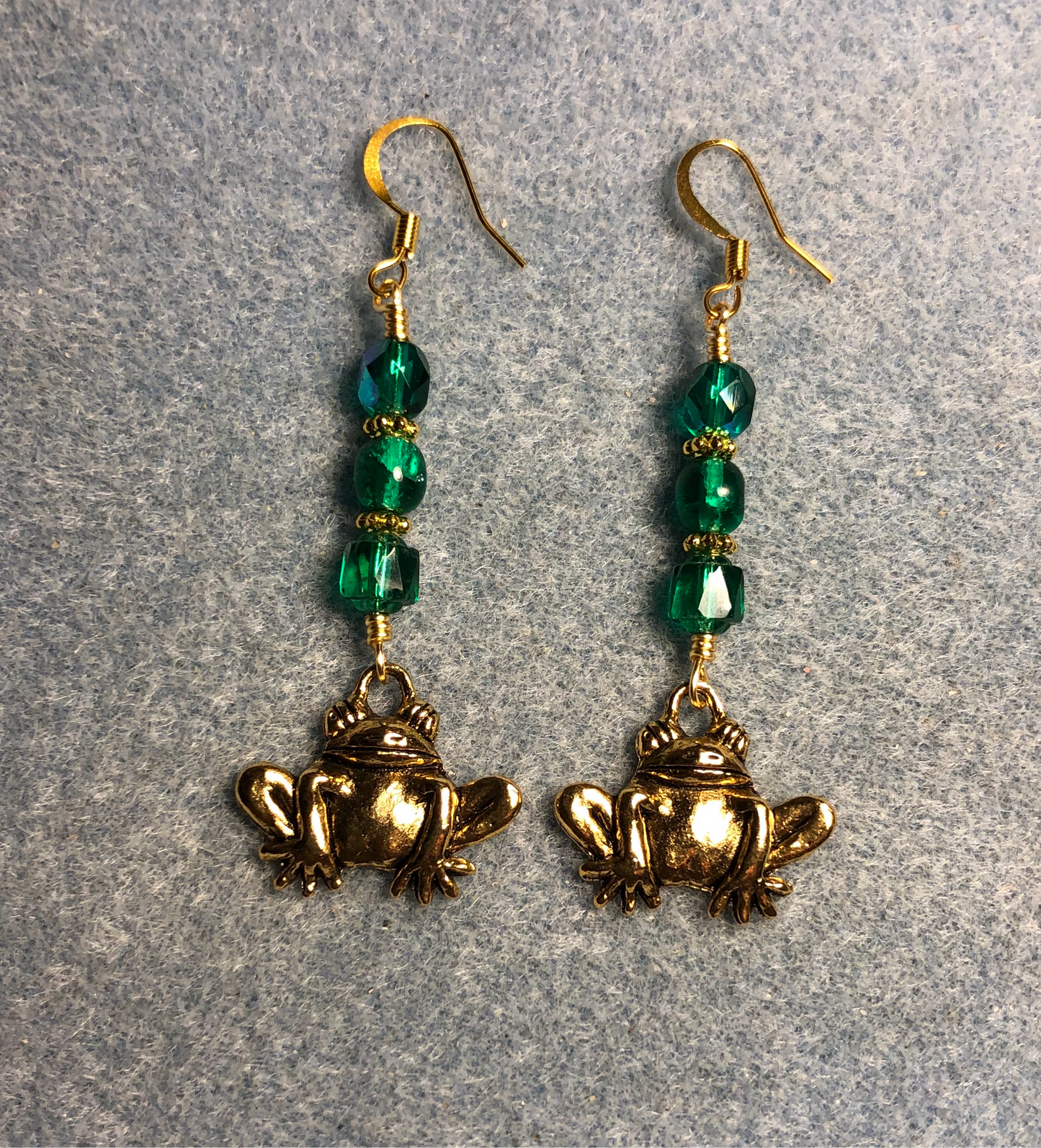 Large gold frog charm earrings adorned with teal Czech glass beads