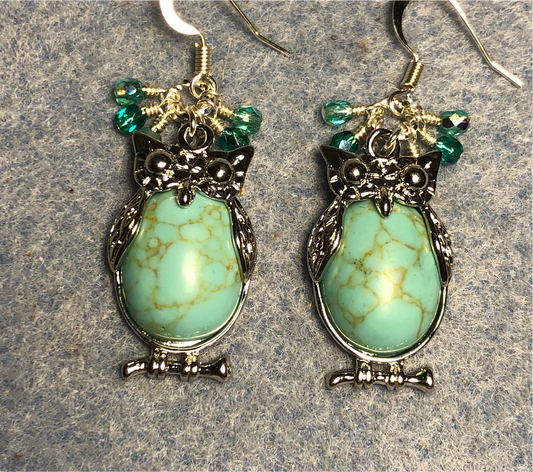 Large silver and turquoise howlite gemstone owl charm earrings adorned with small dangling turquoise Czech glass beads.