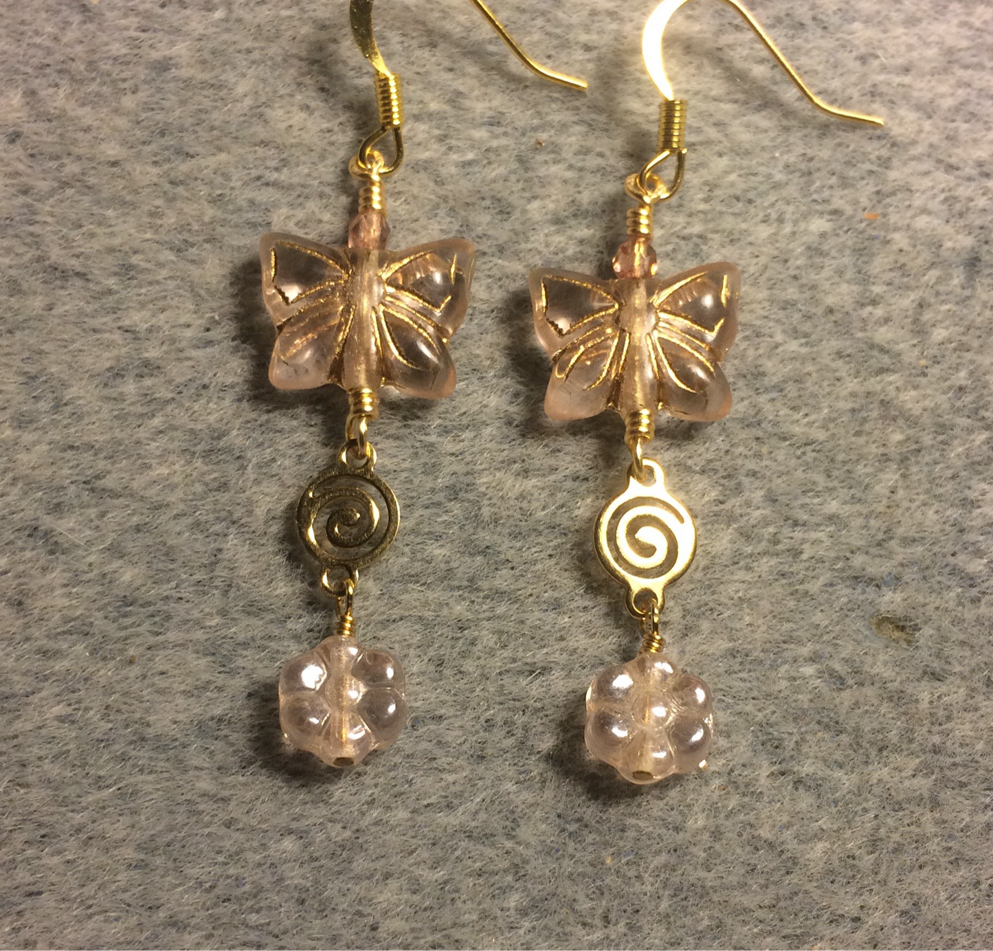 Rose pinkish gold Czech glass butterfly bead earrings adorned with gold swirly connectors and rose gold Czech glass daisy beads.